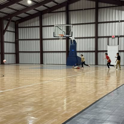 Students playing basketball in the school gym